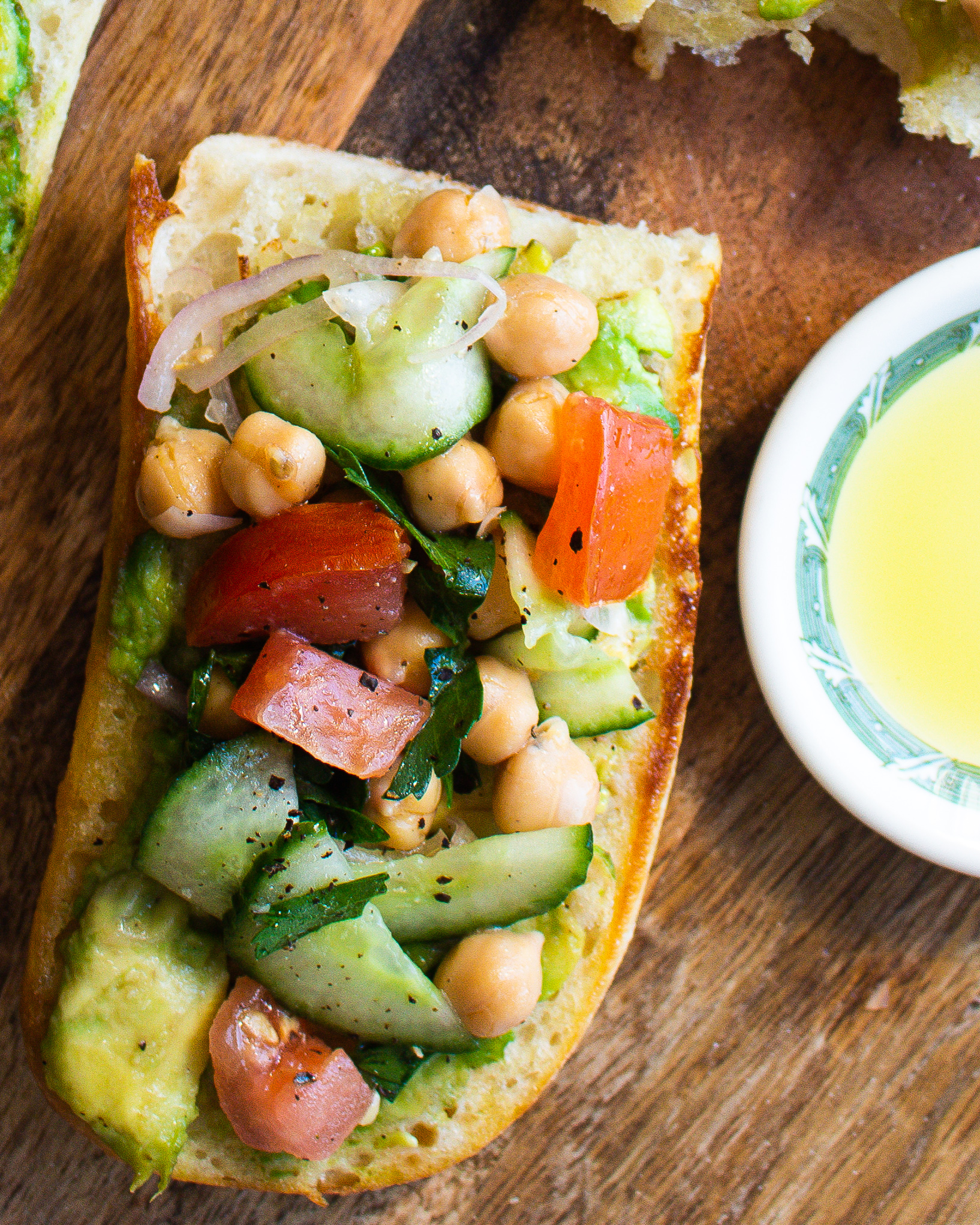 Chickpea salad on a crusty baguette with olive oil and avocado