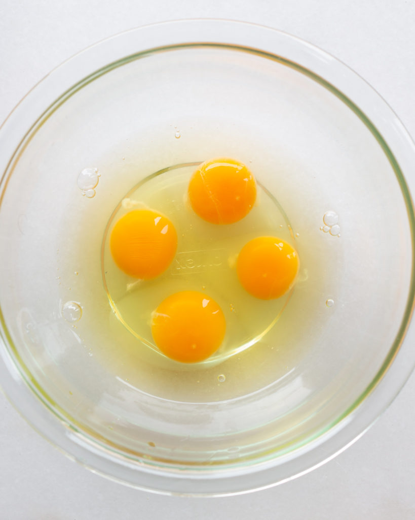 4 raw eggs in bowl