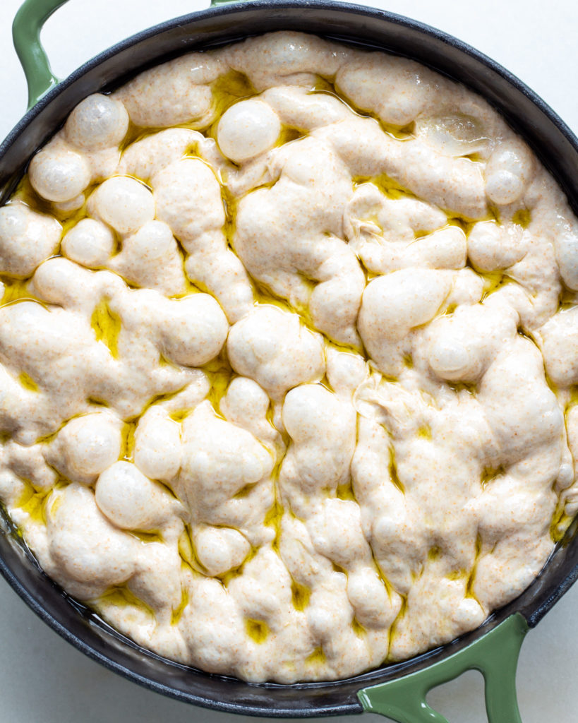 Dimpled focaccia dough with olive oil