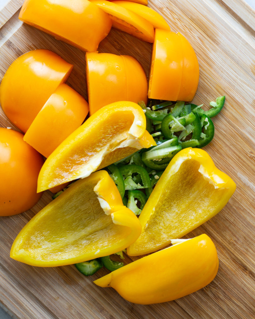 Yellow peppers, golden tomatoes and jalapeños, sliced