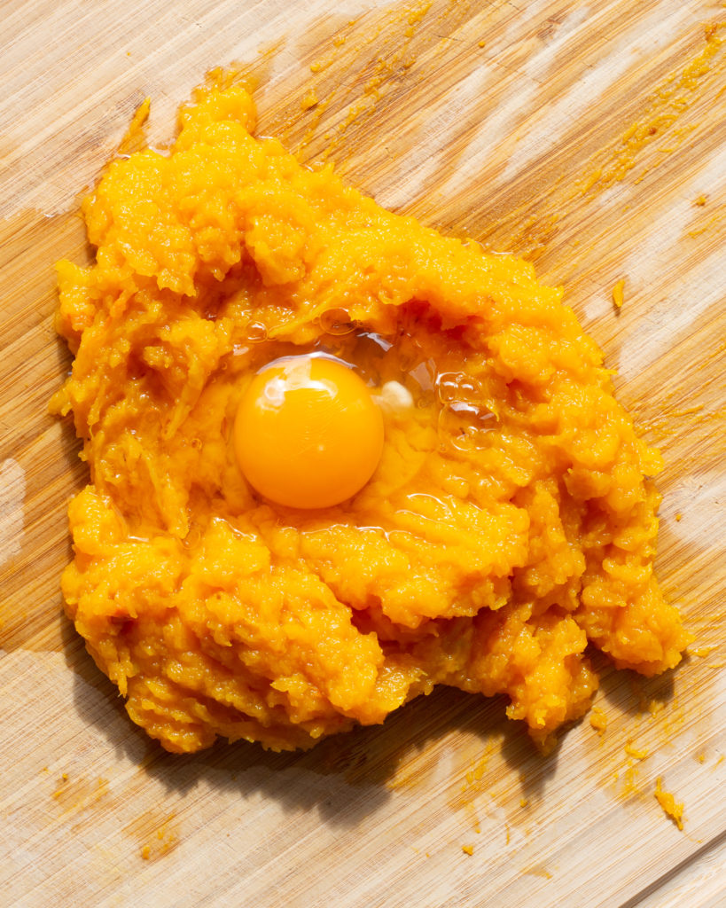 Cooked butternut squash meat with raw egg