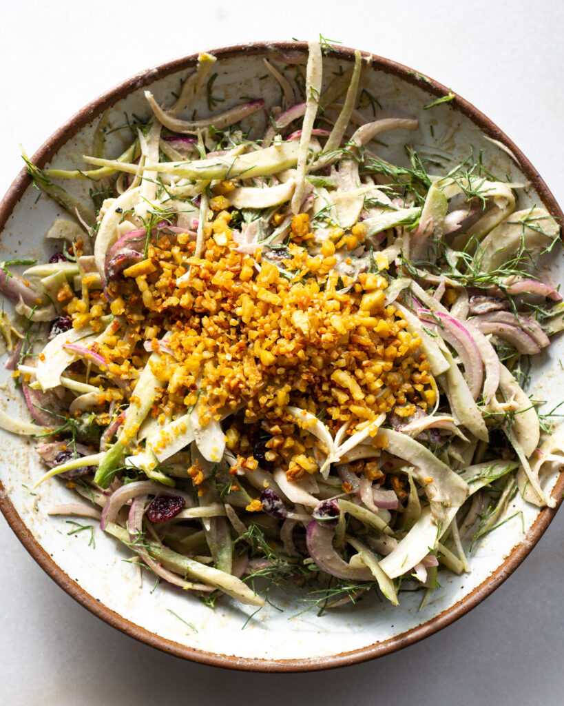 Adding tempeh to fennel salad.