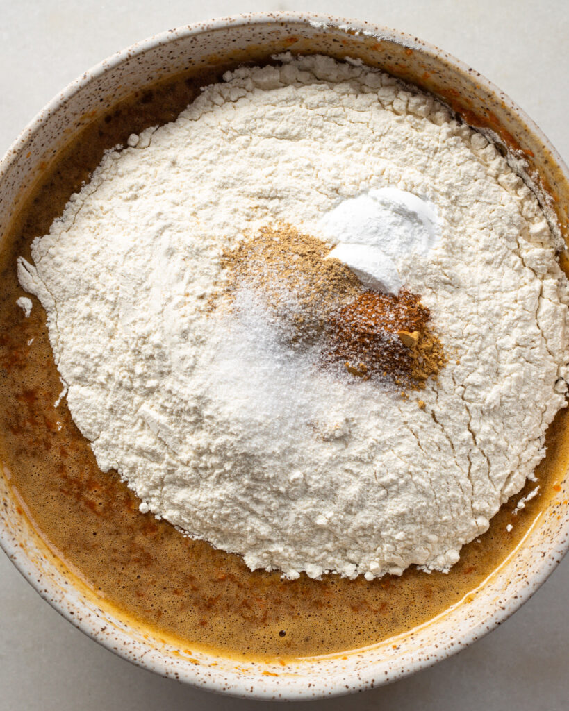 dry and wet ingredients layered together in a mixing bowl