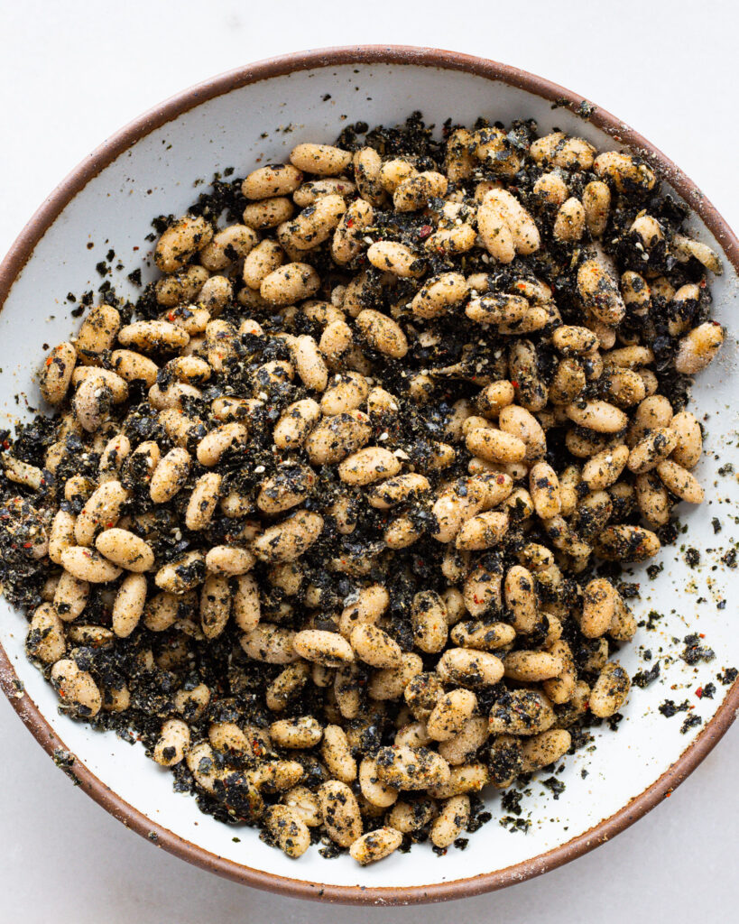 beans tossed with dry ingredients in a bowl