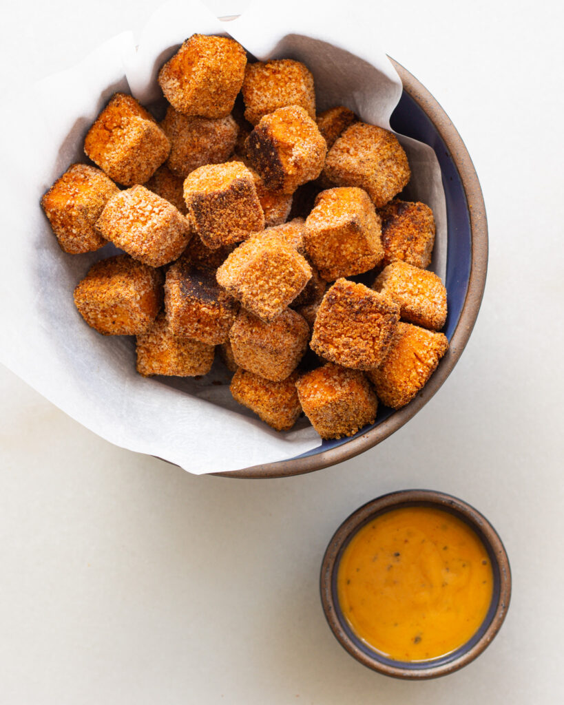 Hummus nuggets in a bowl with dipping sauce