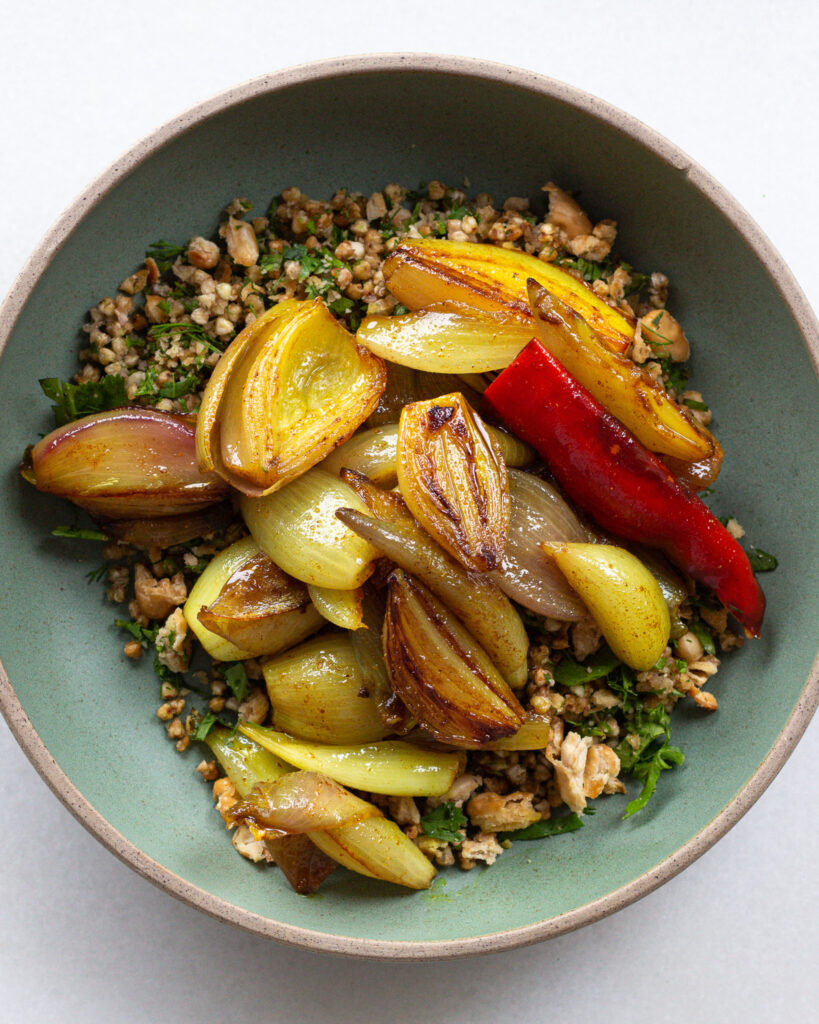 Turmeric shallots with crispy buckwheat and beans in a bowl