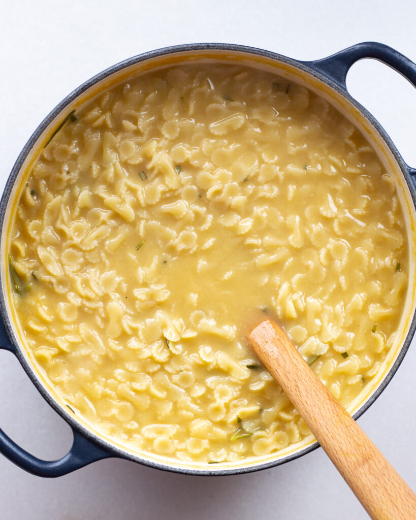 miso butter pastina in a pot with wooden spoon
