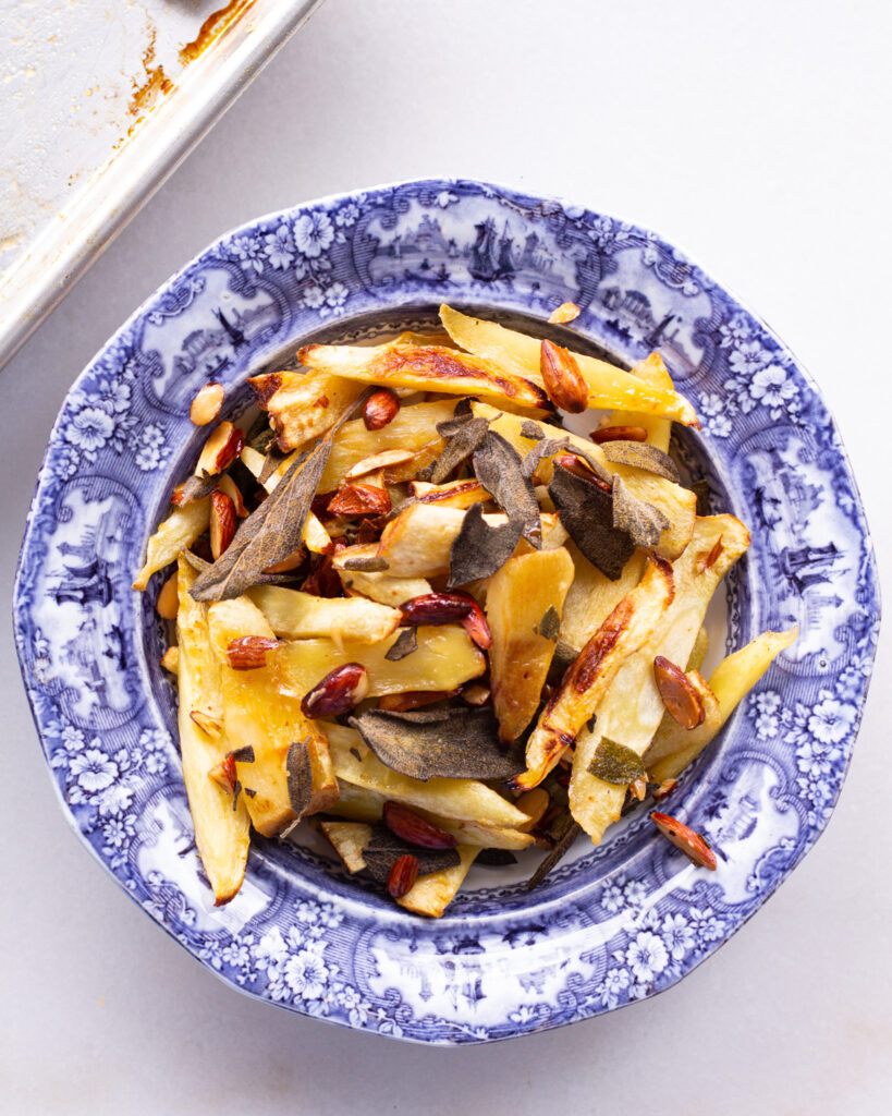 Finished crispy parsnips with honey vinegar almonds