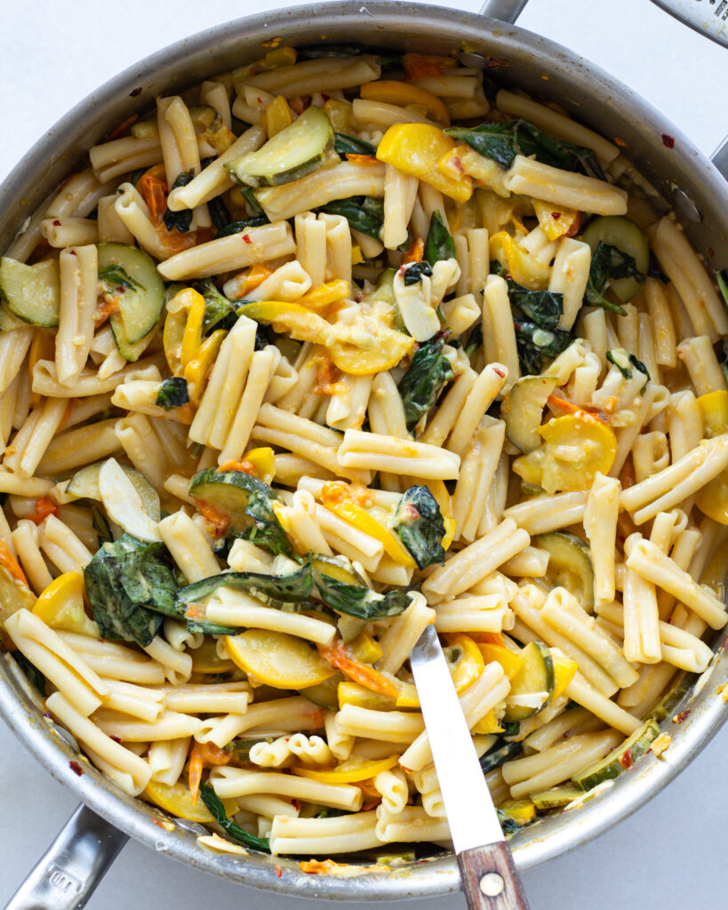 Cooked pasta and ingredients added to pan