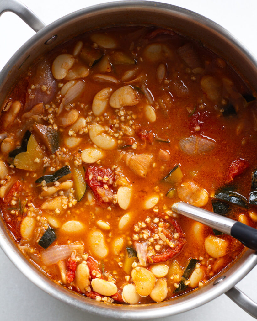 brothy beans in pot with buckwheat