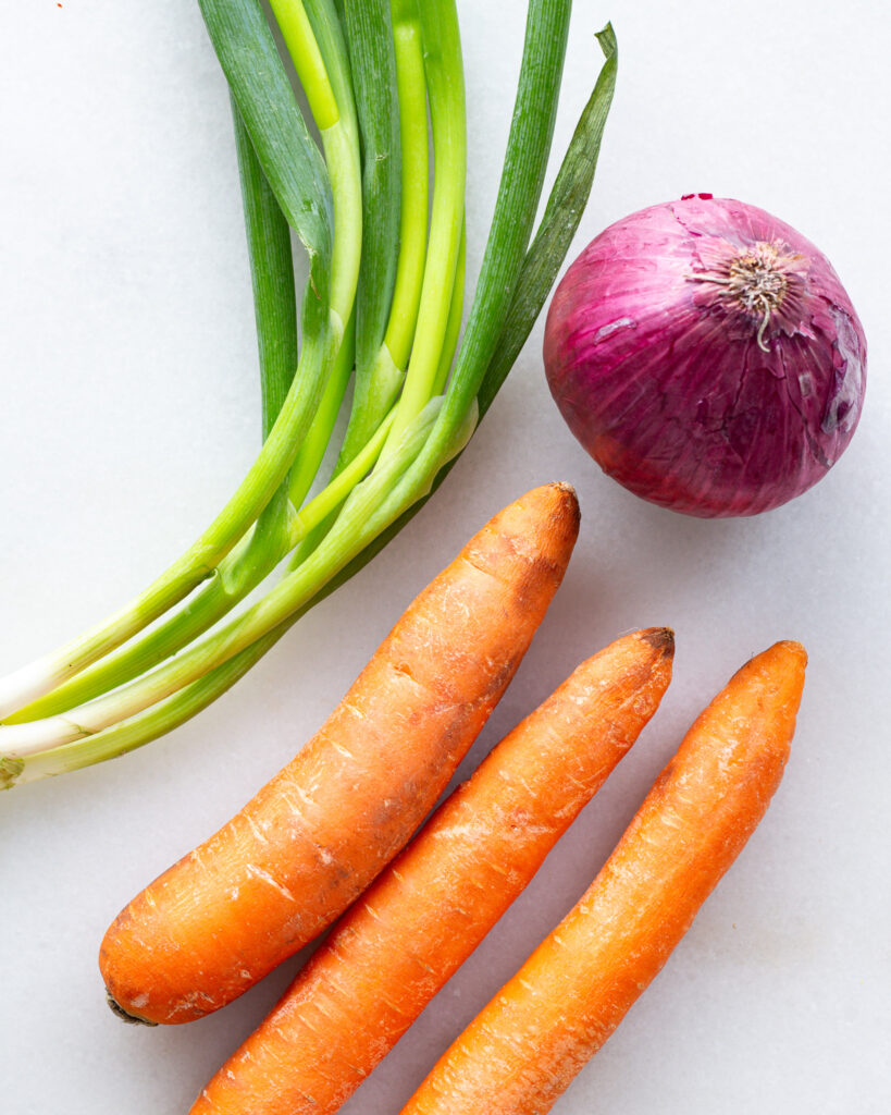 scallions and red onion and carrots, ingredient shot