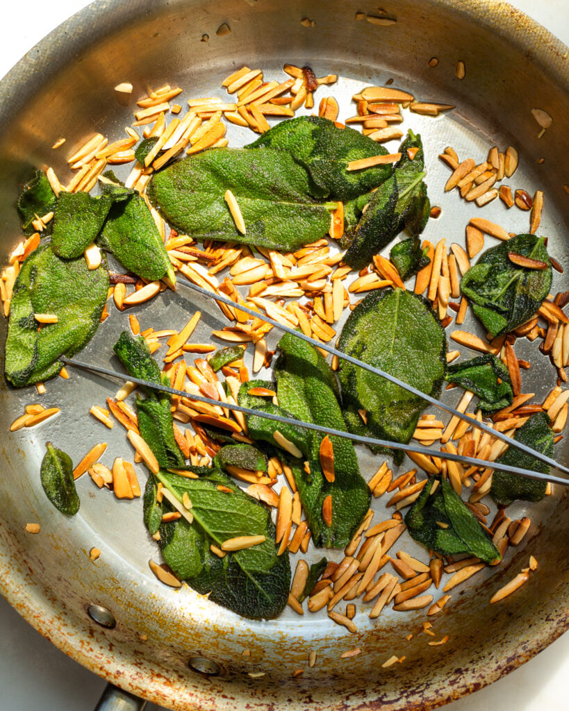 Toasted almonds and crispy sage in a sauté pan.