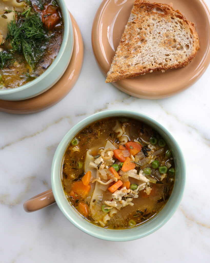 Bread and a bowl of vegetarian chicken noodle soup 
