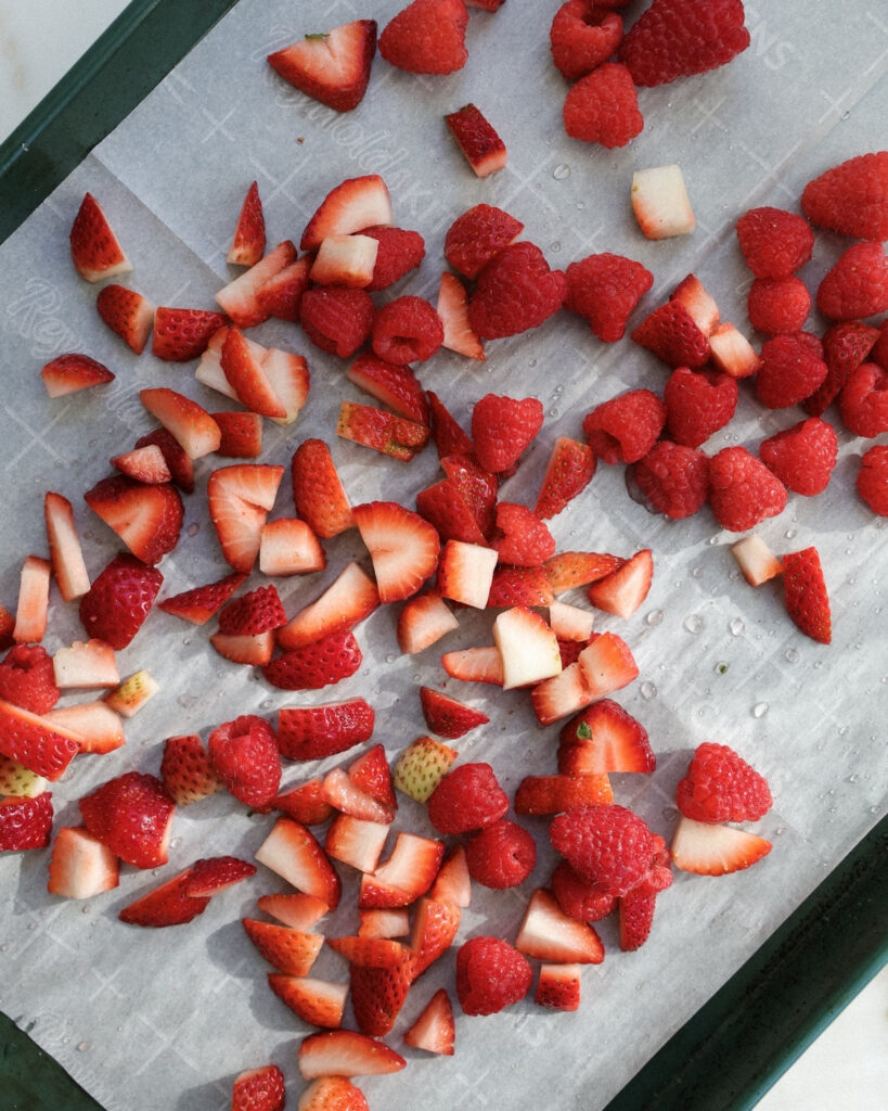 strawberries and raspberries on a baking sheet