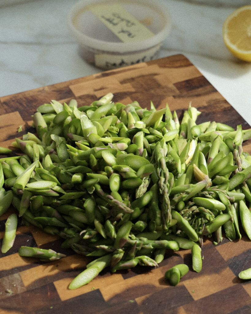 chopped asparagus on a cutting board.