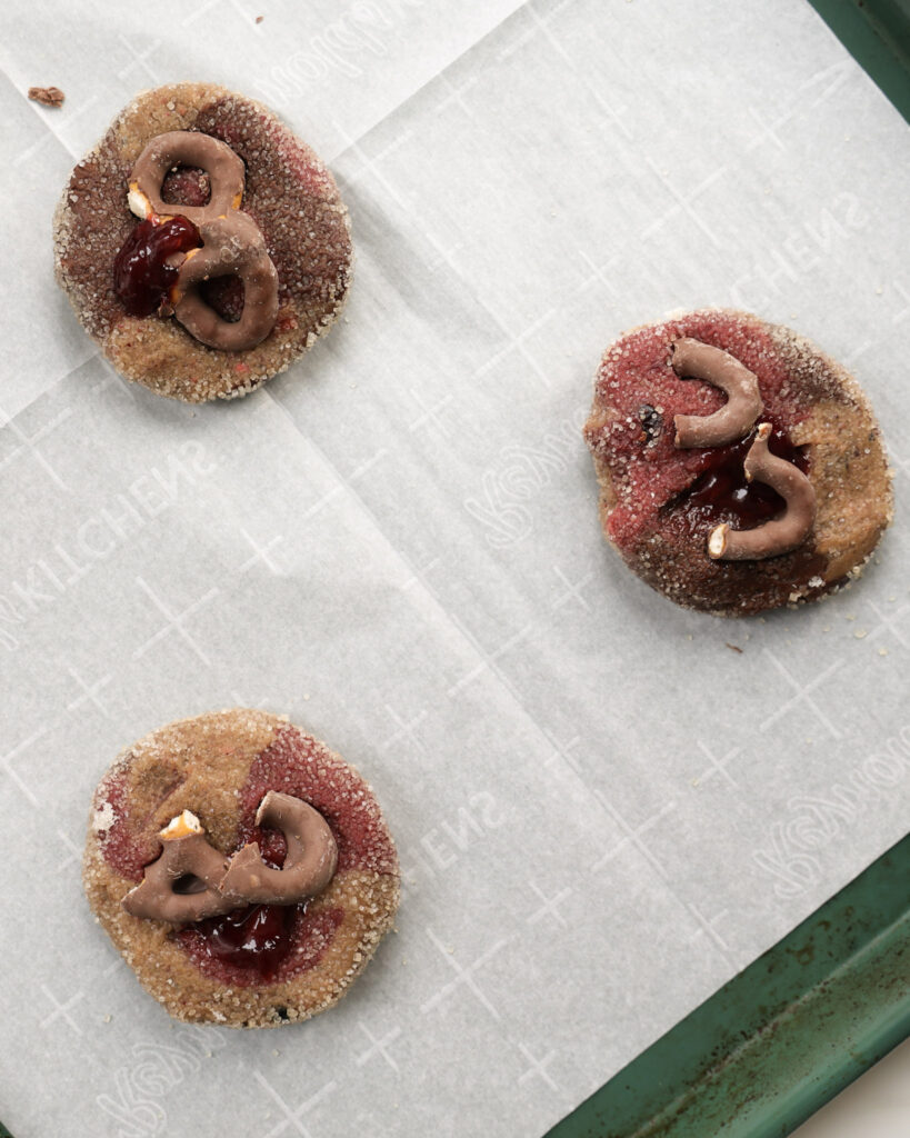 Marbled cookie dough with chocolate covered pretzels on top.