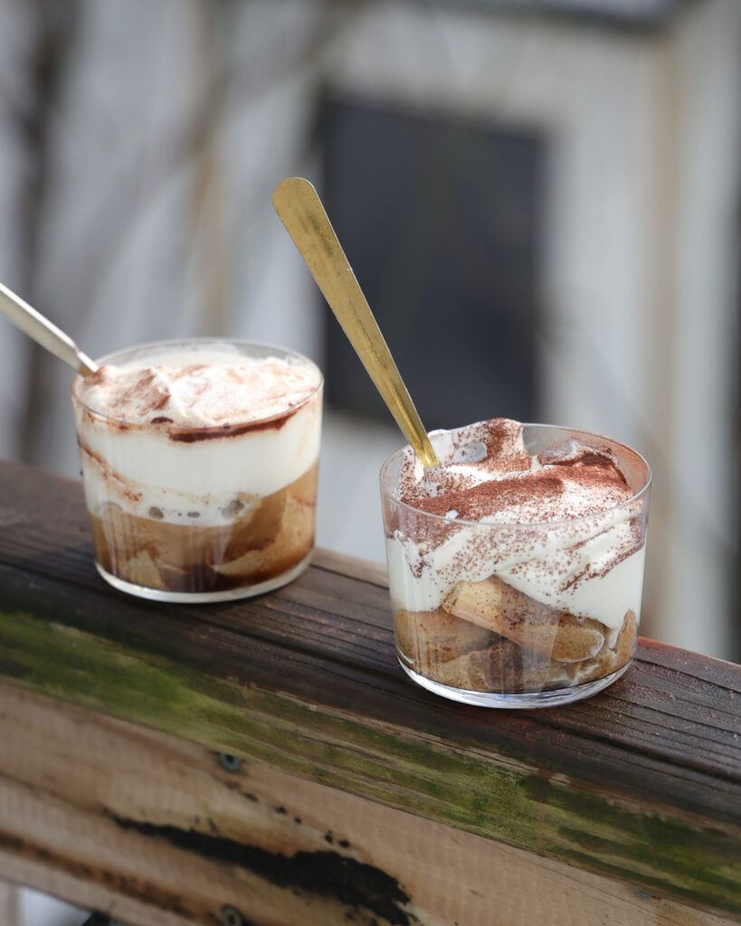 Two cups of tiramisu affogatos with spoons, ready to be eaten