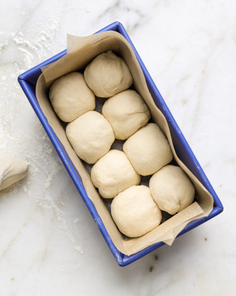 vegan brioche rolls in a loaf pan.