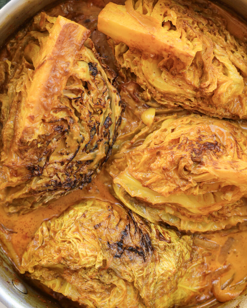 Seared cabbage wedges that have been roasted in braising liquid.