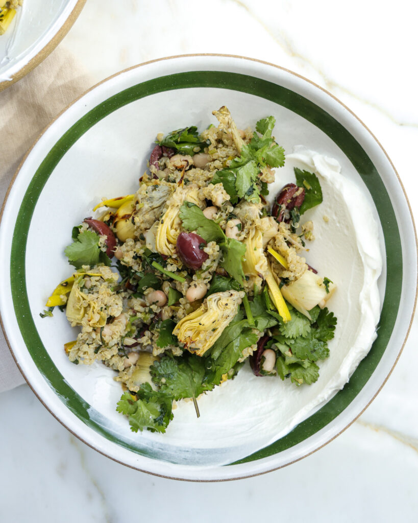 lemon quinoa with roasted artichokes in a bowl.