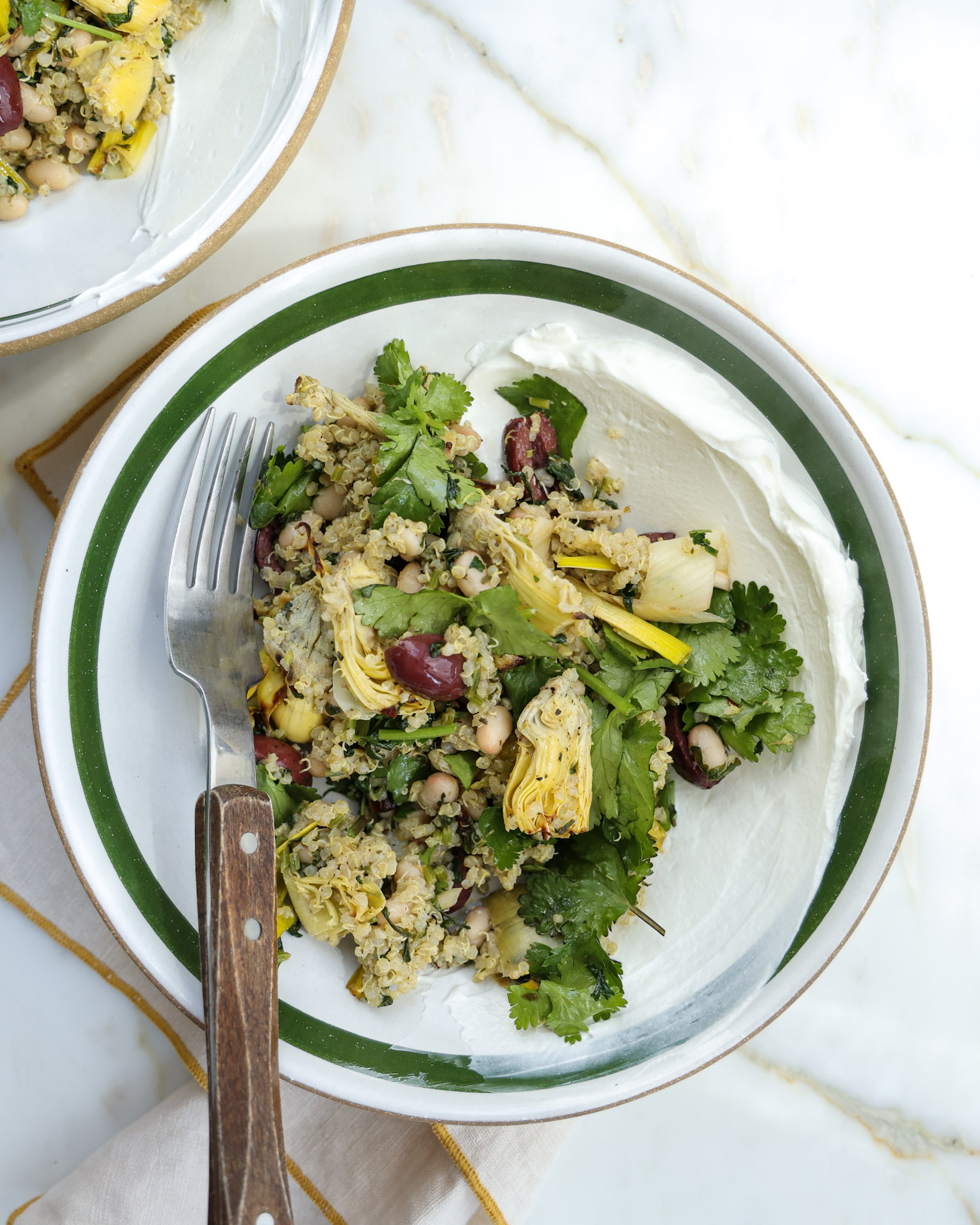 lemon quinoa with roasted artichokes in a bowl.