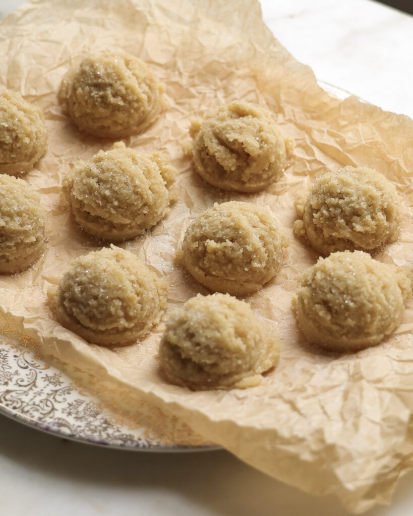 sugar cookie dough balls on a plate.