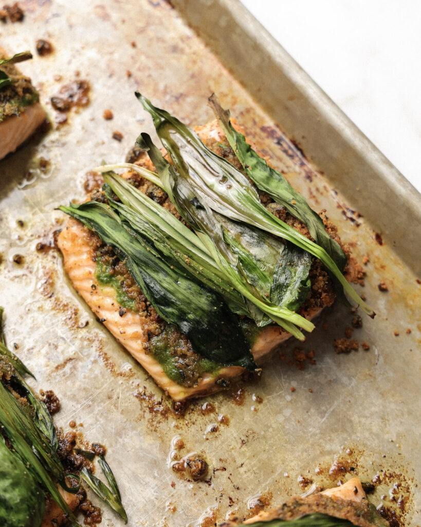 ramp wrapped salmon on a baking sheet.