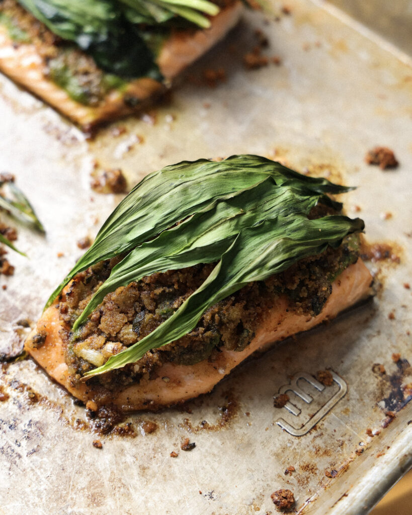 ramp wrapped salmon on a baking sheet.