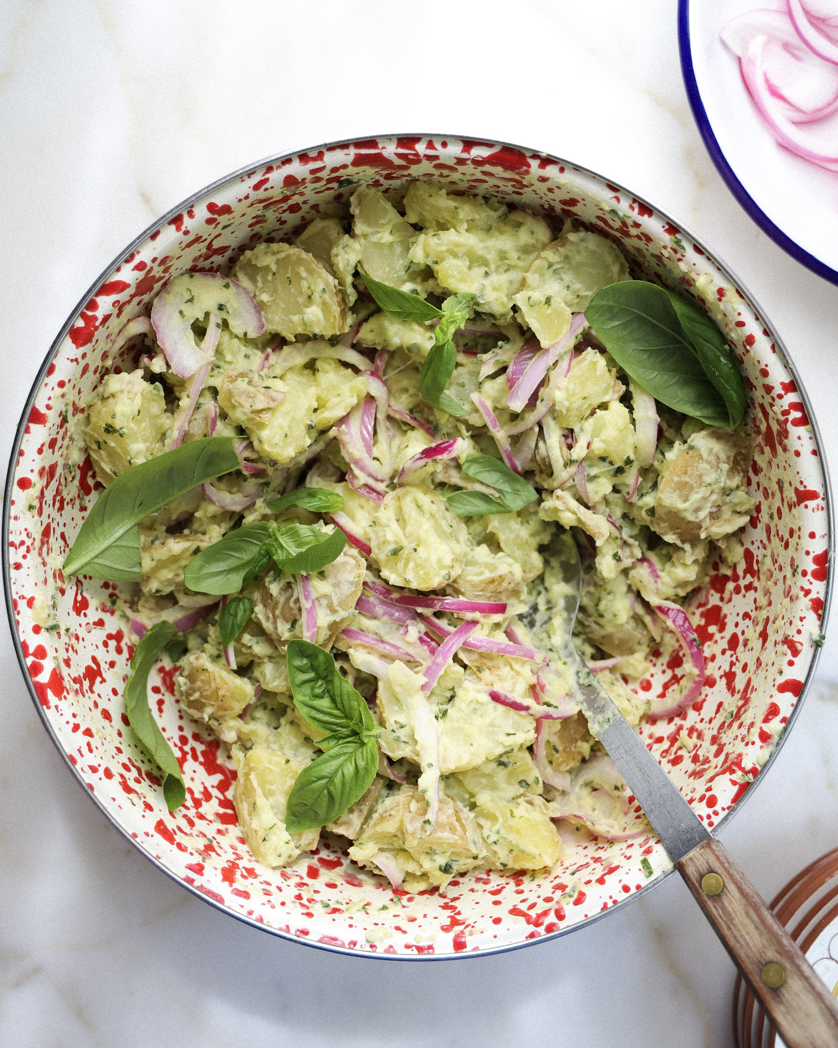 Basil potato salad in a bowl.