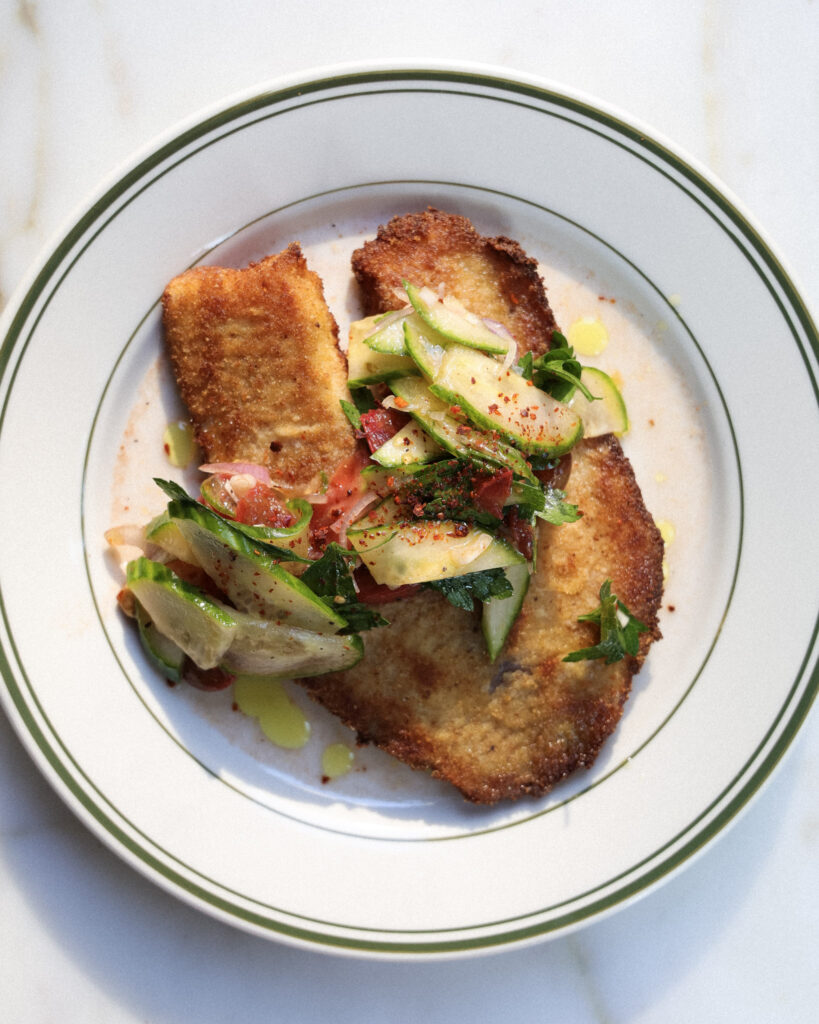 Tomato salad spooned over fried tilapia.