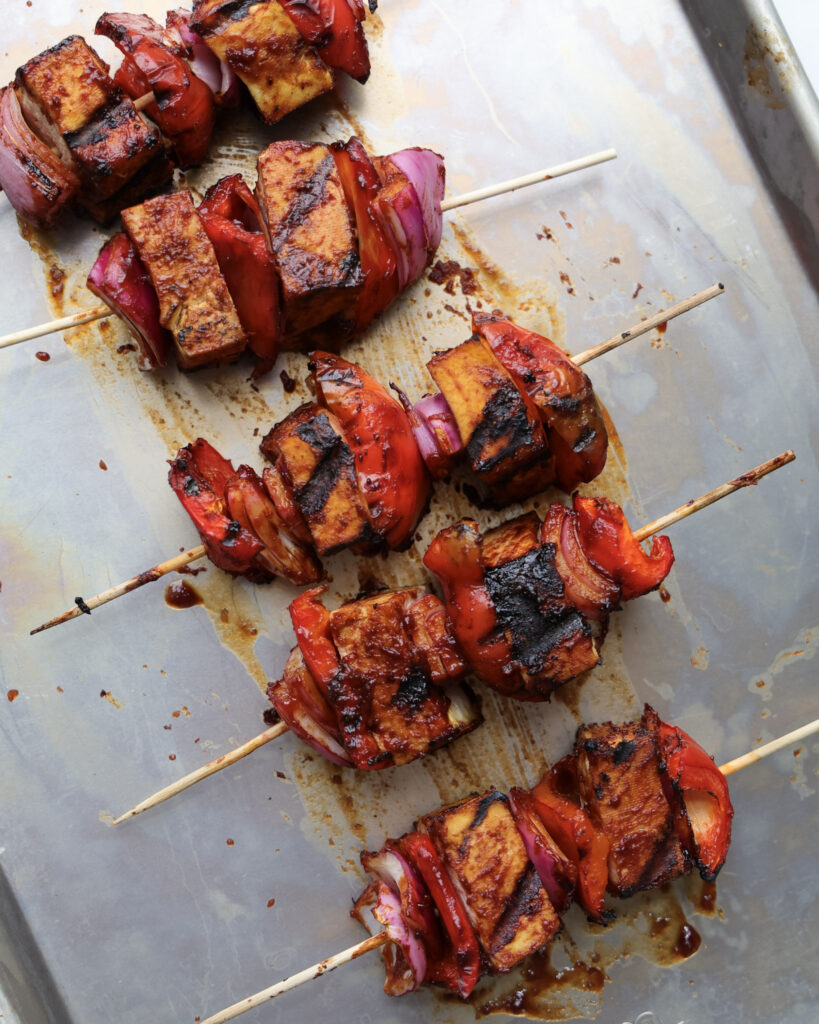 Grilled tofu skewers on a baking sheet.