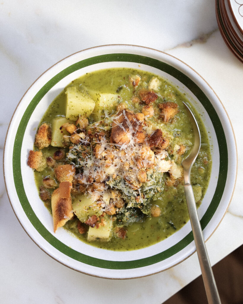 Caesar salad bean soup in a bowl topped with chickpeas, croutons and parmesan.