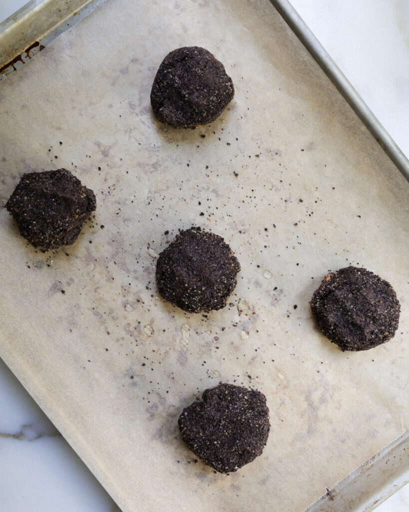 death by chocolate cookie dough balls on a baking sheet.