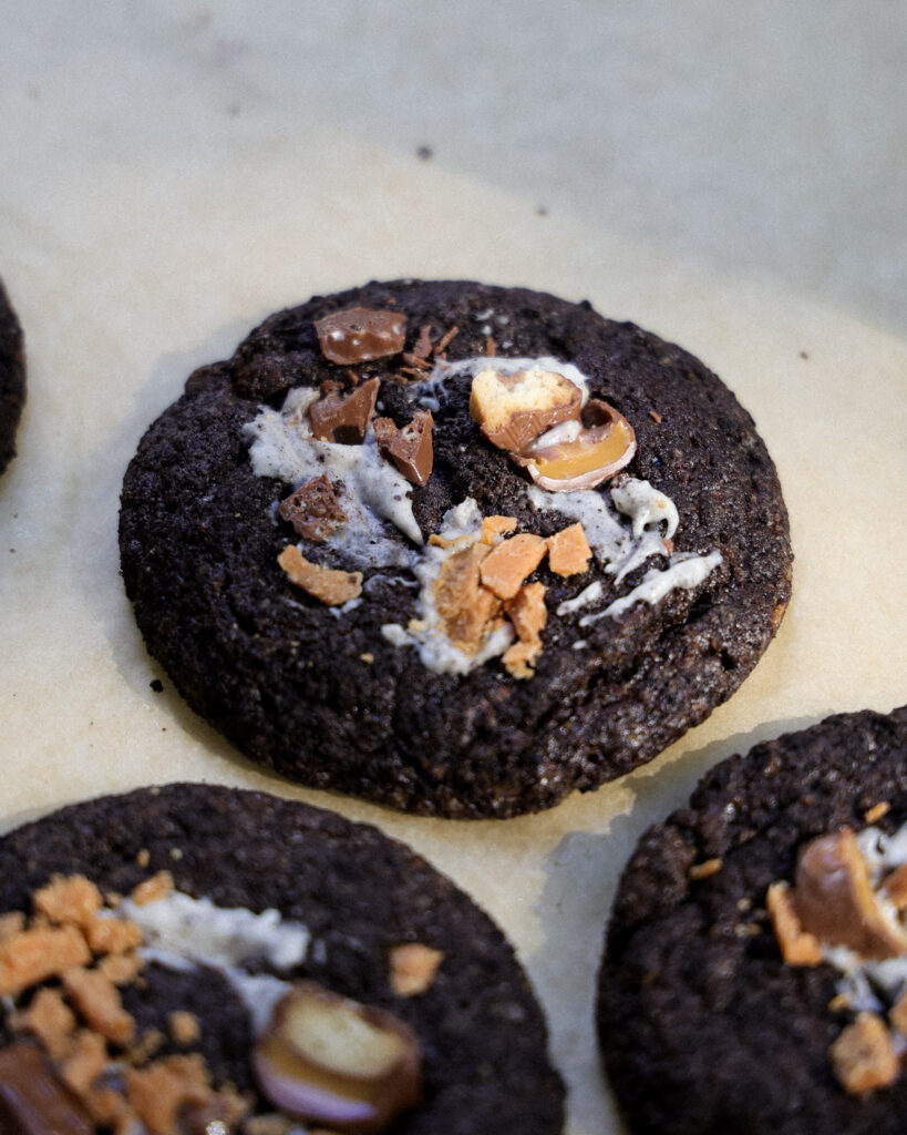 baked death by chocolate cookies topped with candy and oreo cream.