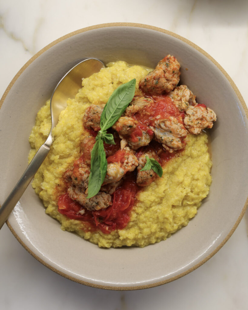 Fresh polenta & tomato sausage in a bowl.