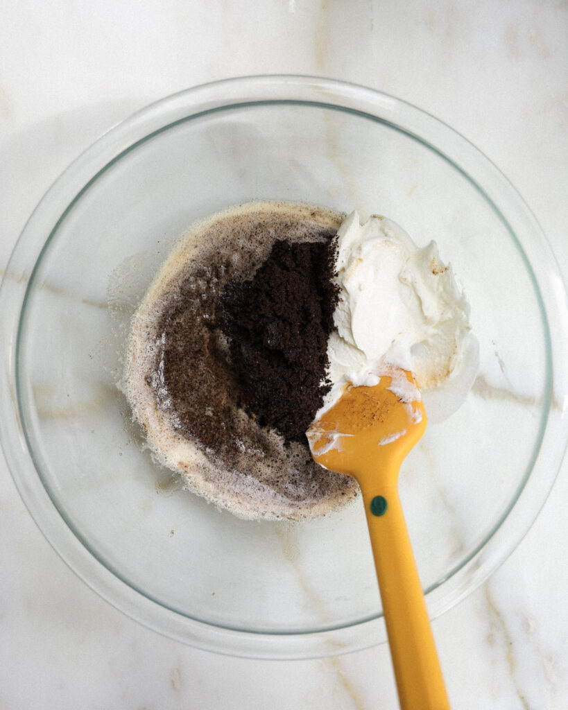 blitzed oreos being mixed with butter and greek yogurt.